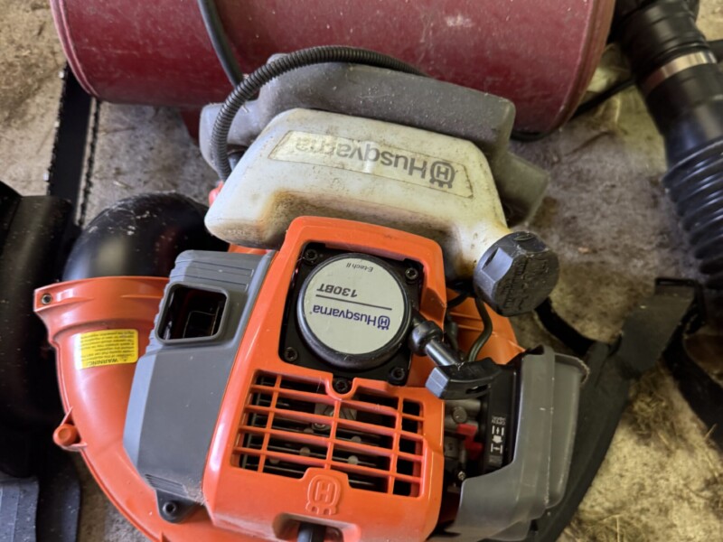 Lot 36: Husqvarna, 130 BT, Back pack blower, works. Electric chain saw and air pig